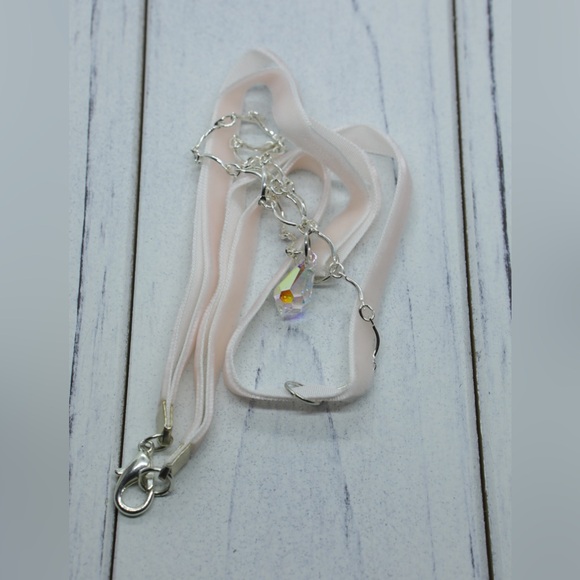 A small crystal tear pendant on a pink velvet and silver tone chain. - Picture 3 of 3